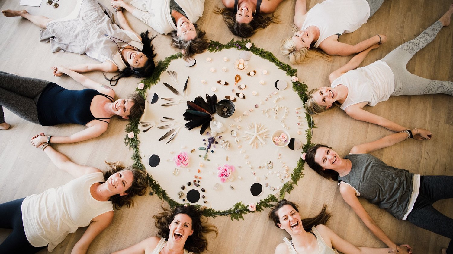 Women laying around a circle on the floor